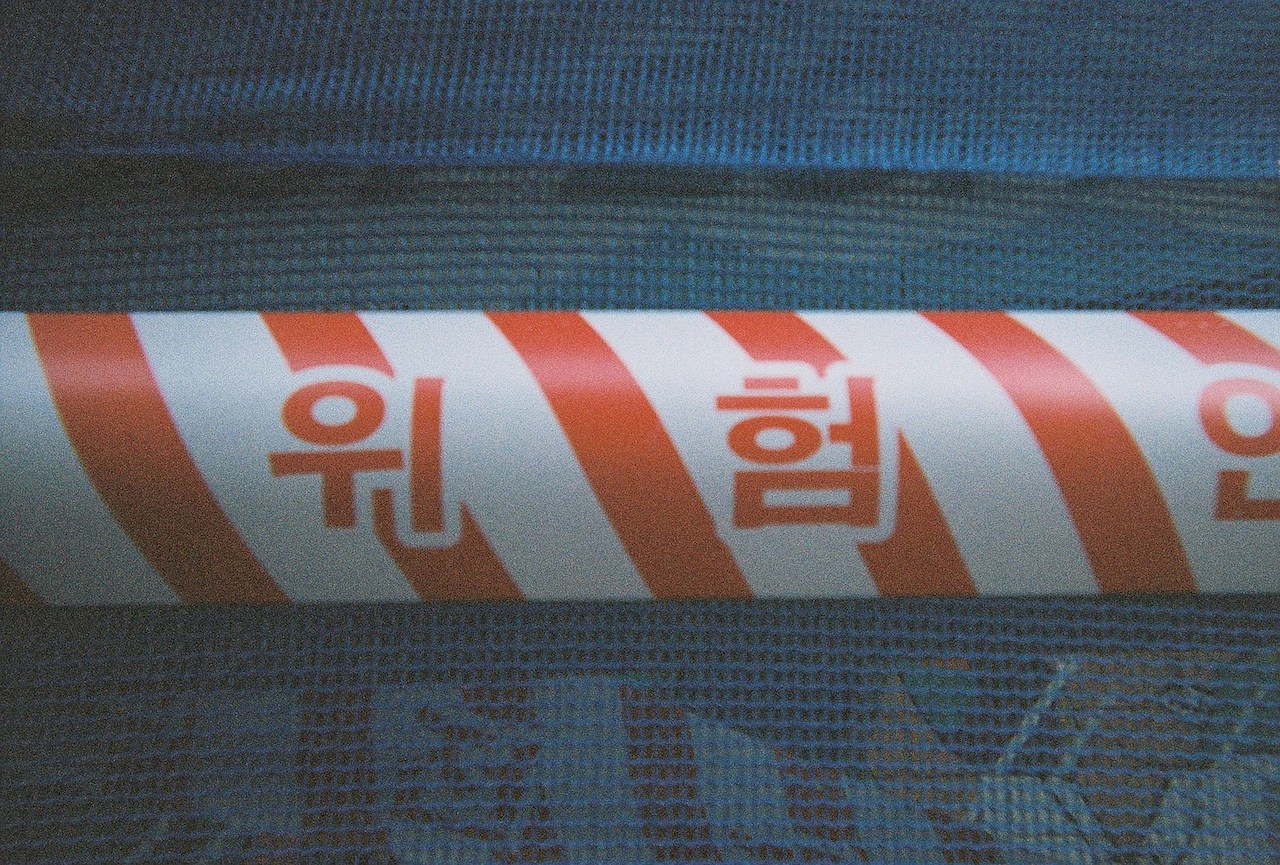 red and white tape. Photo by Chanhee Lee on Unsplash